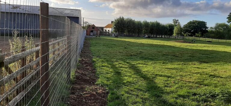 Fence looking down towards house 768x354